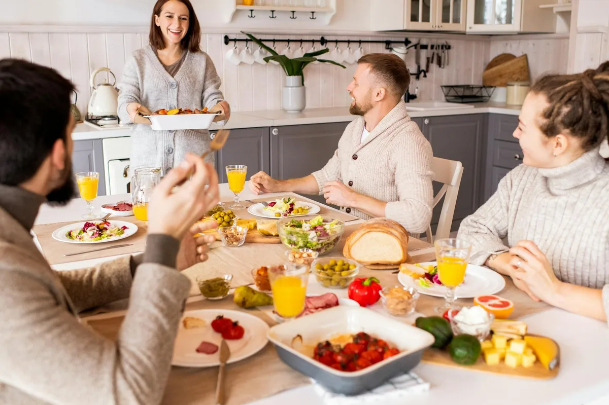 Group of friends enjoying a vibrant meal indoors, sharing laughter and good food.
